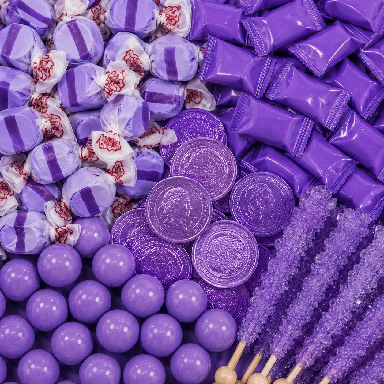 Purple candy assortment featuring striped taffy, purple wrapped candies, chocolate coins, gumballs, and rock candy sticks.