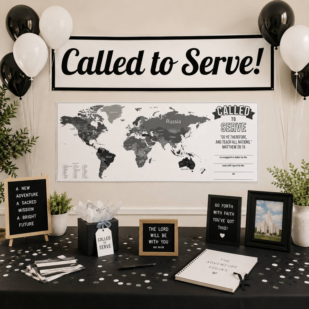 Called to Serve missionary party display featuring a black and white banner, world map mission assignment poster, black and white balloons, letter board signs, greenery, a temple photo, confetti, and a guest book on a black tablecloth.