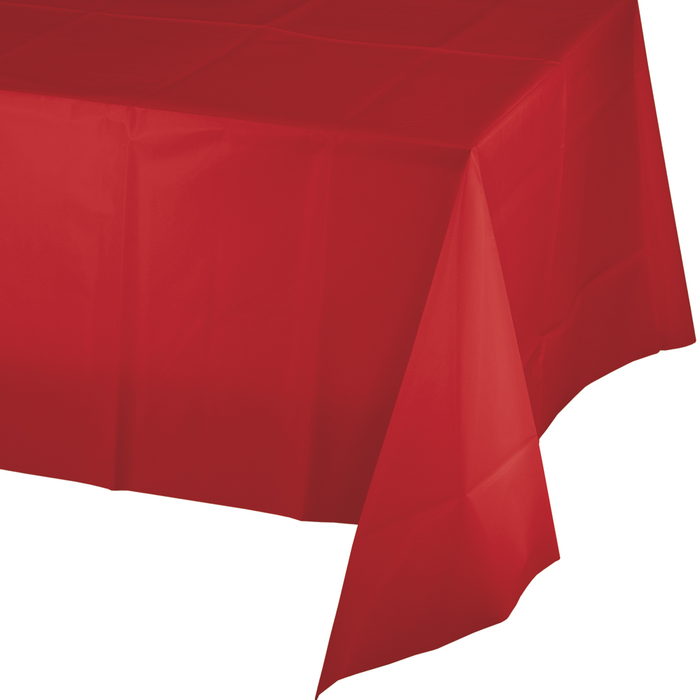 Bright red plastic tablecloth draped over a table, showing the fabric's drape and texture against a white background.