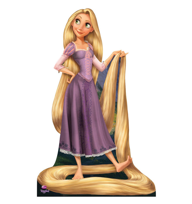 Lifesize cardboard standup of a young woman with very long golden blonde hair wearing a purple medieval-style dress with pink sleeves, barefoot and smiling.