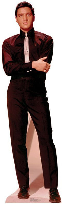 Life-size cardboard standup figure of a man wearing a burgundy velvet suit jacket, white dress shirt, and matching burgundy pants, posed with arms crossed.