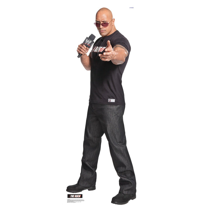 Lifesize cardboard standup of a bald man wearing sunglasses, a black WWE t-shirt, and dark jeans, holding a microphone while pointing toward the viewer.