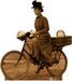 Sepia-toned cardboard standup figure of a woman in a brown dress and black hat sitting on a bicycle with extended arms, resembling a classic film character.