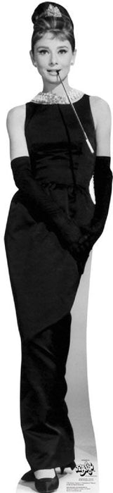 Black and white life-size cardboard standup cutout of a woman in an elegant sleeveless black gown with long gloves, holding a cigarette holder and wearing an upswept hairstyle.
