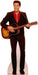 Cardboard standup cutout of a man in a brown velvet suit and red shirt holding a sunburst acoustic guitar, life-size figure with reddish-brown hair smiling at the camera.