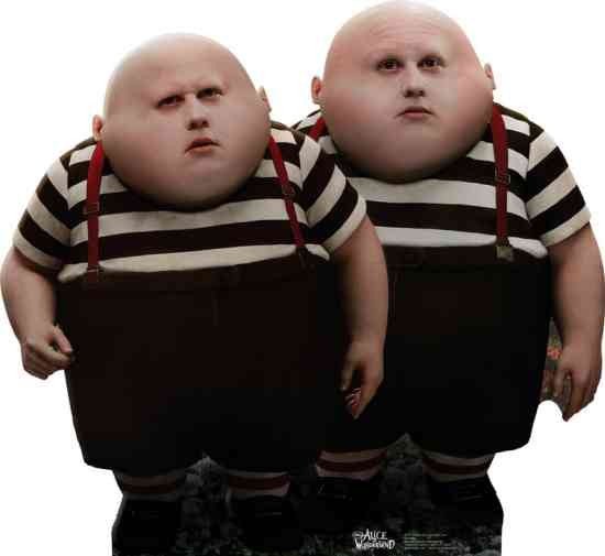 Two identical life-sized cardboard standups depicting round-faced characters wearing striped shirts with red suspenders and black pants, positioned side by side.