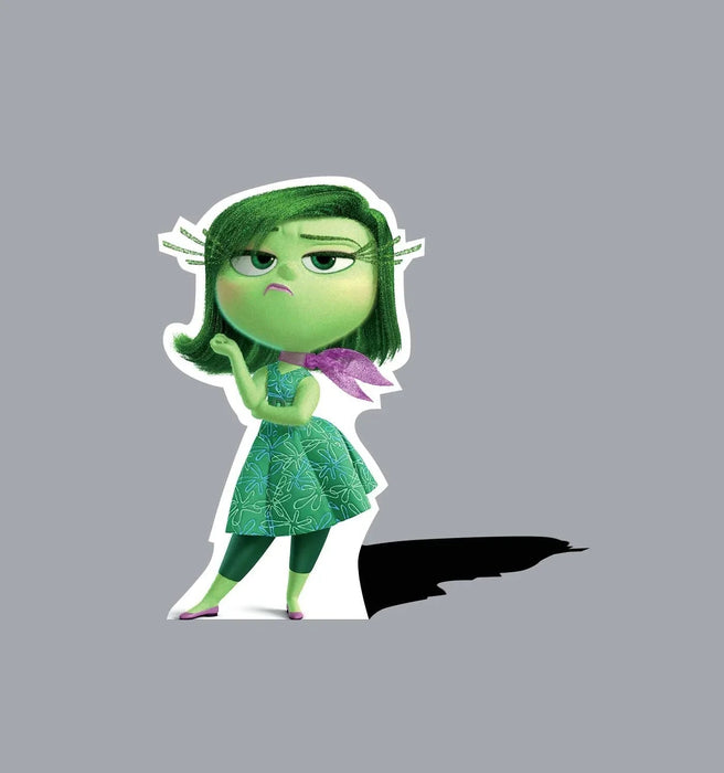 Green-skinned animated character with long dark hair, wearing a green patterned dress and purple accessories, shown in a dismissive pose against a gray background.