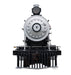White and black steam locomotive #7 with riveted boiler, smokestack, and red cowcatcher mounted on a black display stand.
