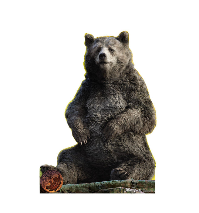 Life-size cardboard standup of Baloo the bear sitting upright with gray and black fur, set against a white background with a yellow outline and decorative forest base element.