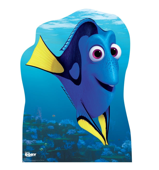 Blue fish character with large pink eyes and yellow fins against an underwater coral reef background on a cardboard standup.