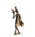Bronze-colored ornate candelabra figure wearing an elaborate coat with decorative details, holding two lit candles, displayed as a cardboard standup.