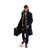 Cardboard standup figure of a young man in a navy wool coat with a striped scarf, holding a wand and vintage suitcase, wearing dark pants and brown boots.