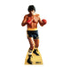Life-size cardboard standup of a boxer in red gloves and black and gold shorts with matching striped socks, labeled Rocky II at the base.