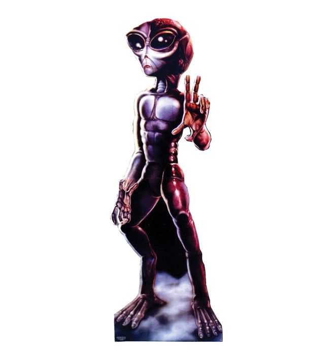 Lifesize cardboard standup of a humanoid alien figure with a gray-purple body, large black oval eyes with glowing pupils, red-tinted head and limbs, and an outstretched hand in a peace gesture.