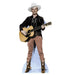 Life-size cardboard standup of a cowboy wearing a white Stetson hat, black embroidered western jacket, tan pants, and ornate brown cowboy boots, holding an acoustic guitar.