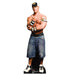 Life-size cardboard standup figure of a muscular man wearing a black and gold cap, white and gold wristbands, blue denim shorts, and white sneakers, posed with arms crossed.