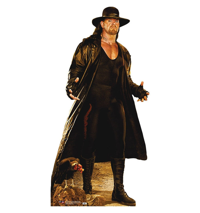 Life-size cardboard standup figure of a man in black leather coat and wide-brimmed hat with a stern expression, standing against a white background.