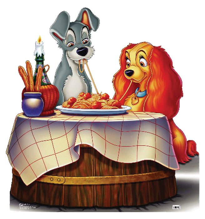 Cardboard standup featuring two animated dogs at a romantic dinner table with pasta, breadsticks, candle, and red-checkered tablecloth.