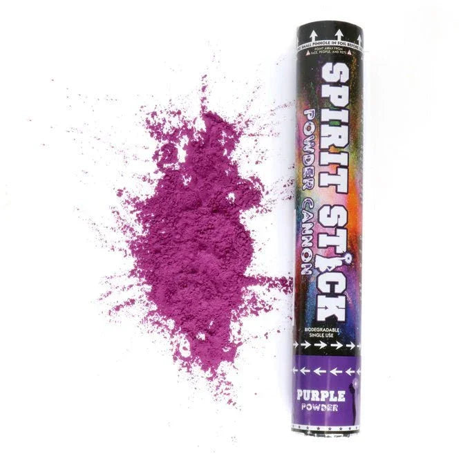 Purple powder cannon with "Spirit Stick" text on black label, shown next to a burst of vibrant magenta powder against a white background.