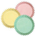 Three overlapping fluted baking cups in pastel yellow, pink, and mint green with ruffled edges displayed against a white background.