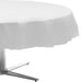 White ruffled round tablecloth draped over a silver cantilever umbrella base, shown against a white background.