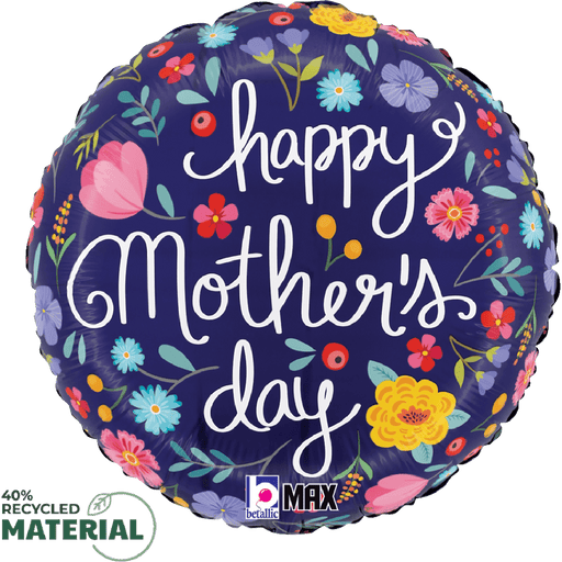 Round foil balloon with dark navy background featuring colorful illustrated flowers in pink, yellow, blue, and red, with white script text reading "happy Mother's day" and small logos in the corner.