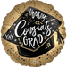 Round gold satin balloon with scalloped edges, black graduation cap center featuring white and gold "Hooray Congrats Grad" text, stars, and decorative foliage.