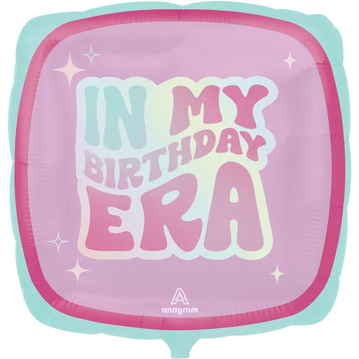 Square mylar balloon with turquoise and pink color blocking featuring "In My Birthday Era" text in white and pink lettering with decorative sparkle accents.