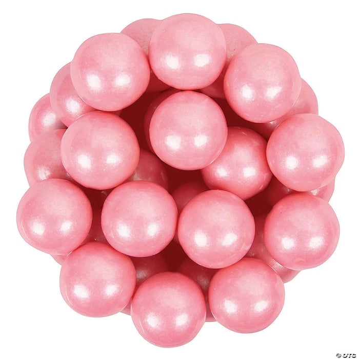 Cluster of shiny pearl pink gumballs with white highlights arranged together against a white background.