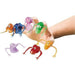 Hand holding seven colorful vinyl finger puppets including orange, blue, pink, green, purple, red, and yellow creatures with googly eyes and flexible limbs.