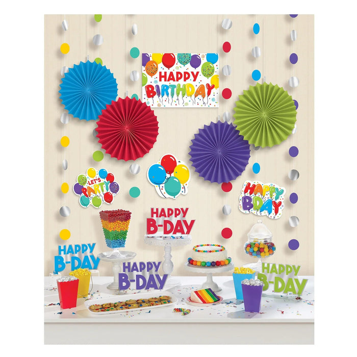 Colorful birthday party decoration kit featuring four large paper fan rosettes in blue, red, purple, and lime green, hanging paper balloon garland strings, small colored ball ornaments, cardboard cake toppers, and table decorations with "Happy B-Day" text in various colors.