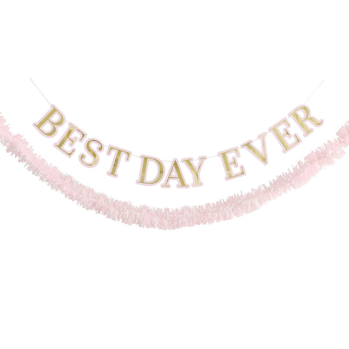 Best Day Ever garland with gold letters outlined in pink and a matching pink fringe garland hanging below