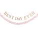 Best Day Ever garland with gold letters outlined in pink and a matching pink fringe garland hanging below