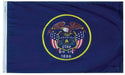 Utah state flag featuring a navy blue background with a yellow circle containing an eagle, American flags, a beehive, and text reading "Industry Utah 1847 1896.