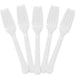 Five translucent white plastic forks with ridged handles arranged in a fan pattern against a white background.