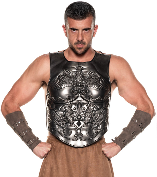 A man modeling a black and silver Roman-style gladiator armor costume vest set against a plain white background.