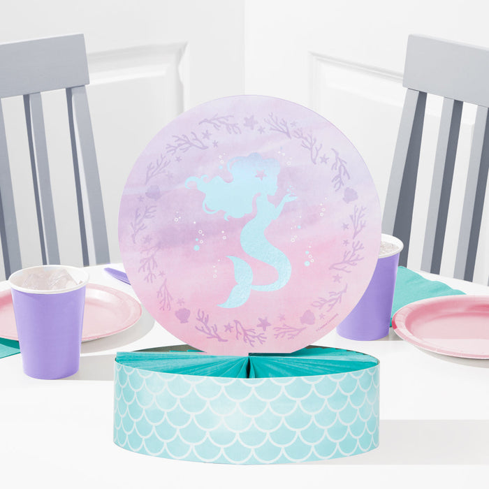 Mermaid Shine honeycomb centerpiece with pastel mermaid silhouette, pink and lavender round topper, and teal mermaid-scale base displayed on a party table.