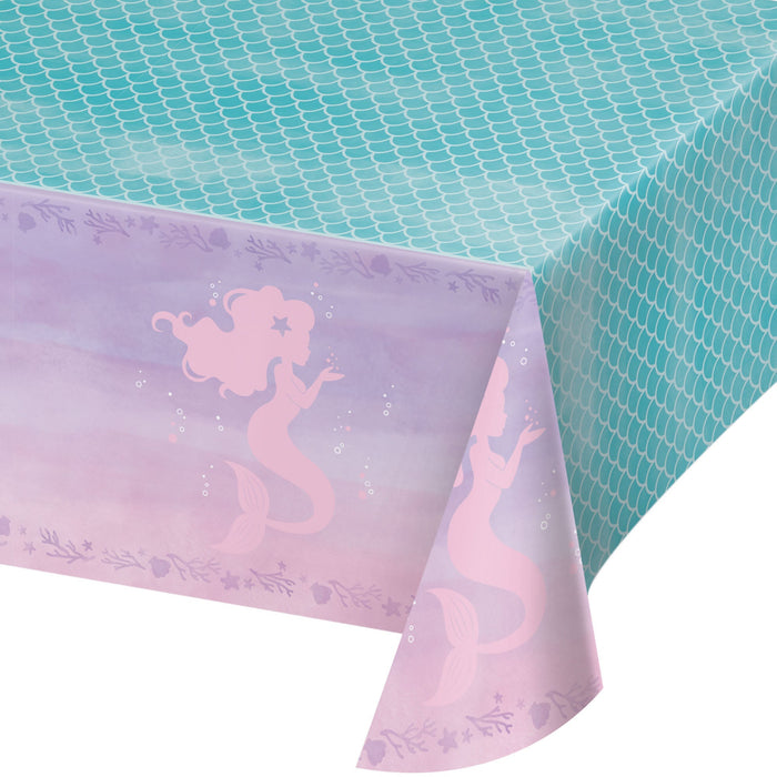 Mermaid Shine plastic tablecover with teal mermaid-scale top, purple ocean border, pink mermaid silhouettes, bubbles, coral, starfish, and seashell accents.