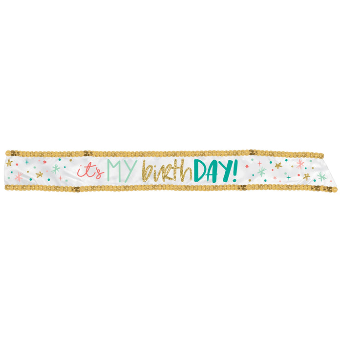 Happy Cake Day fabric birthday sash with white background, gold sequin border, and colorful lettering reading “it’s my birthDAY!” with confetti accents.