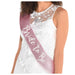 Pink glitter Bride To Be sash worn across a model’s shoulder, featuring metallic script lettering on a bridal shower accessory.