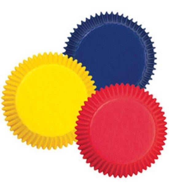 Three stacks of fluted baking cups in yellow, navy blue, and red arranged overlapping on a white background.