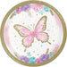 Butterfly Shimmer 7-inch paper plate with a pink watercolor butterfly, gold accents, pastel flowers, hearts, confetti dots, and a gold border.