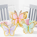 3D Butterfly Shimmer centerpieces in pastel pink, purple, and teal with gold borders displayed on a party table with pink cups and plates.