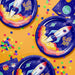 Space-themed paper plates with rocket designs and 'BLAST OFF!' text on a yellow background with colorful confetti.