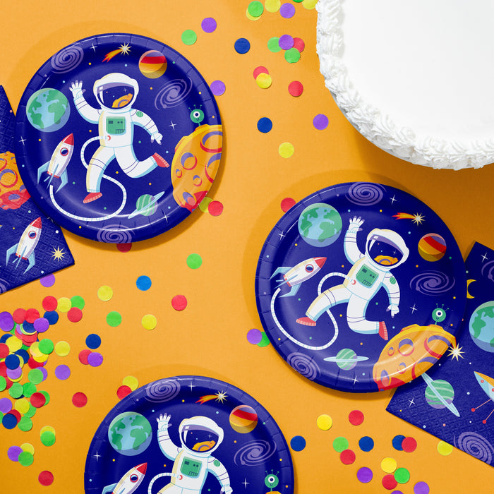 Space-themed paper plates with astronauts, planets, and rockets on a yellow background with colorful confetti.