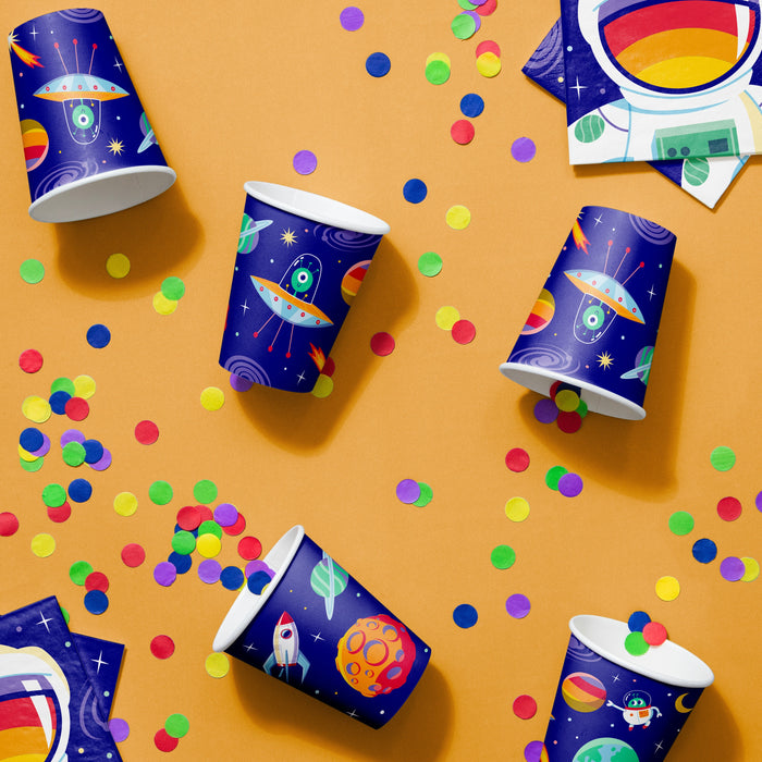 Space-themed party cups with colorful confetti on an orange background