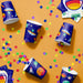 Space-themed party cups with colorful confetti on an orange background