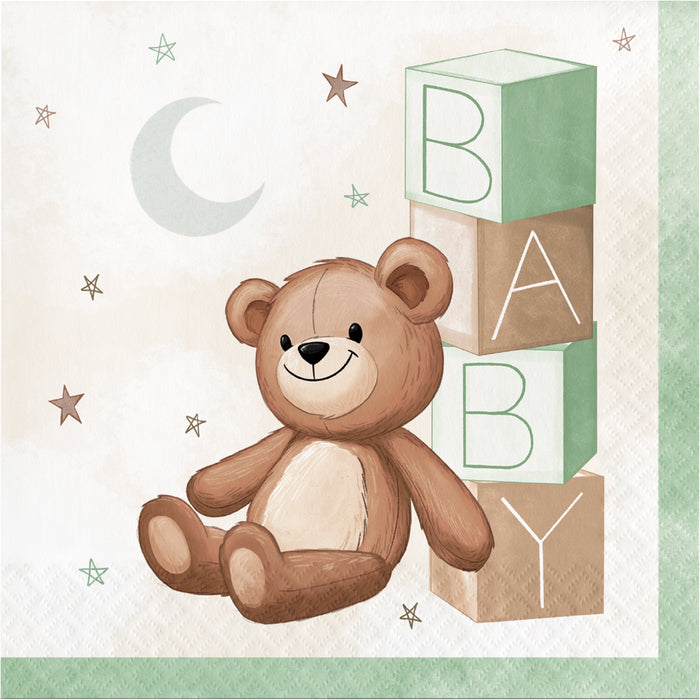 Teddy Bear luncheon napkin with smiling bear, stacked baby blocks spelling “BABY,” moon, stars, and soft green border accents.