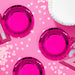 Turning Pink 7-inch paper foil plates in bright hot pink metallic finish, styled on a pink party table with confetti and coordinating party décor, 8-count pack.