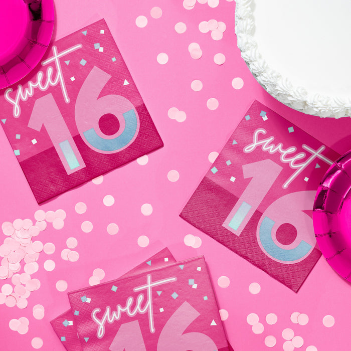 Turning Pink 16th birthday luncheon napkins in bright pink with large “16” and confetti accents, styled on a pink party table with matching tableware and décor, 16-count pack.
